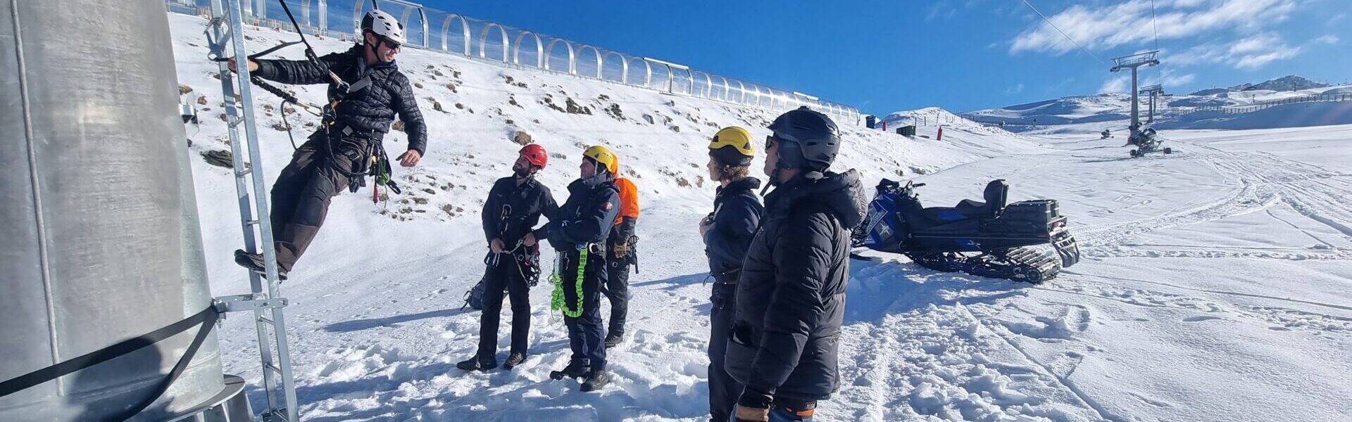 A ropes instructor mounts a chairlift