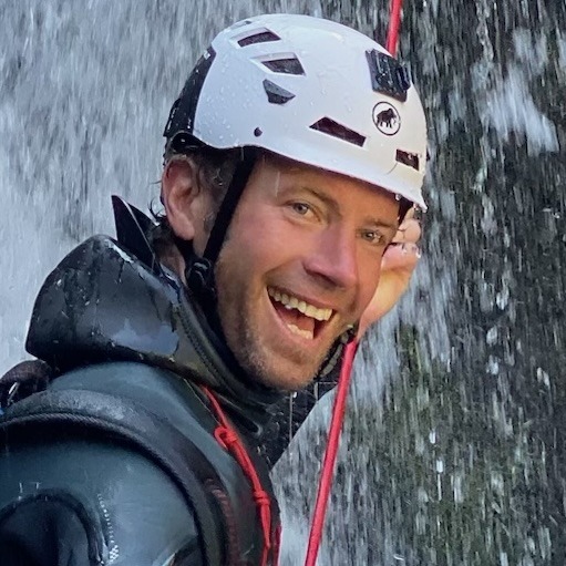 Man smiling in a waterfall